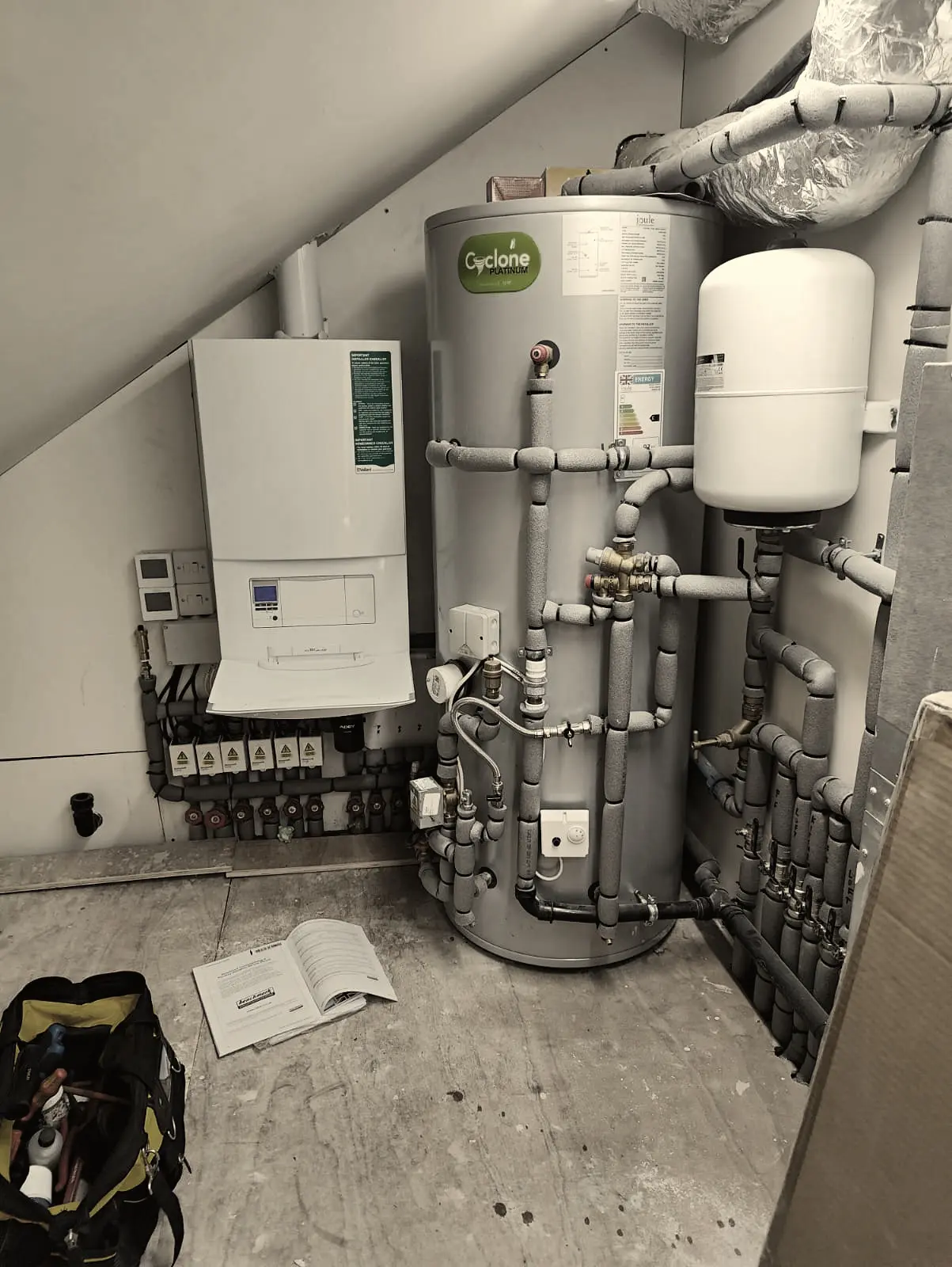 Vaillant boiler and Cyclone hot-water cylinder installed with insulated services in a compact London loft plant room.