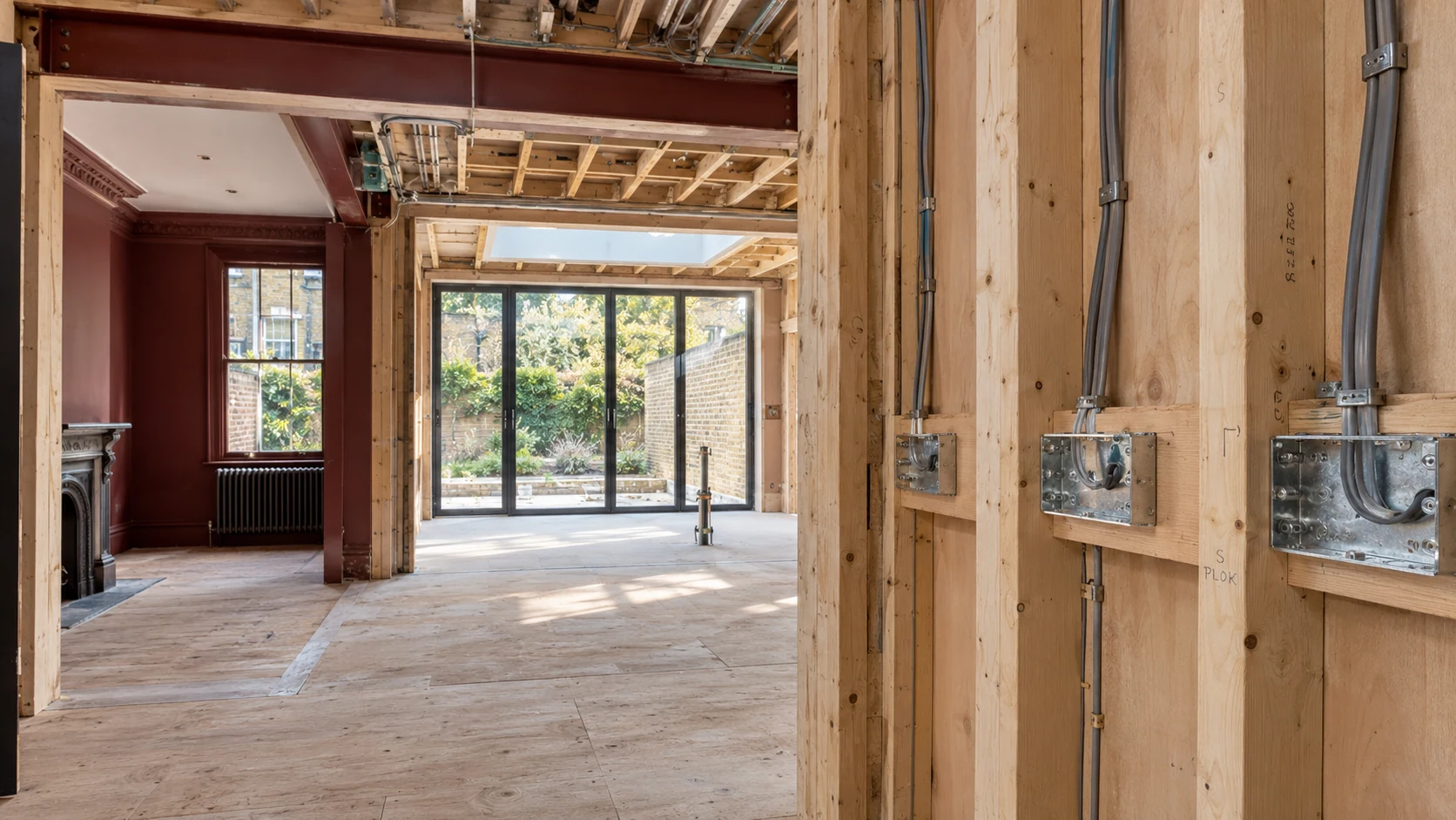 First-fix cable routes and back boxes in an unfinished extension adjoining a retained period room