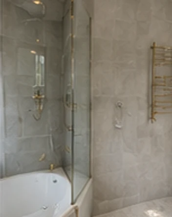 Styled bathroom design with brass fittings and a heated towel rail, Kensington W8.