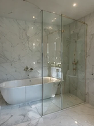 Styled marble bathroom design with a freestanding bath and glass walk-in shower, Kensington W8.