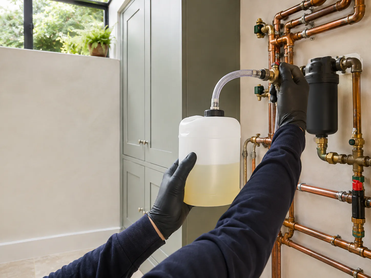 Fresh corrosion inhibitor being added to a central heating circuit after cleaning in Hampstead