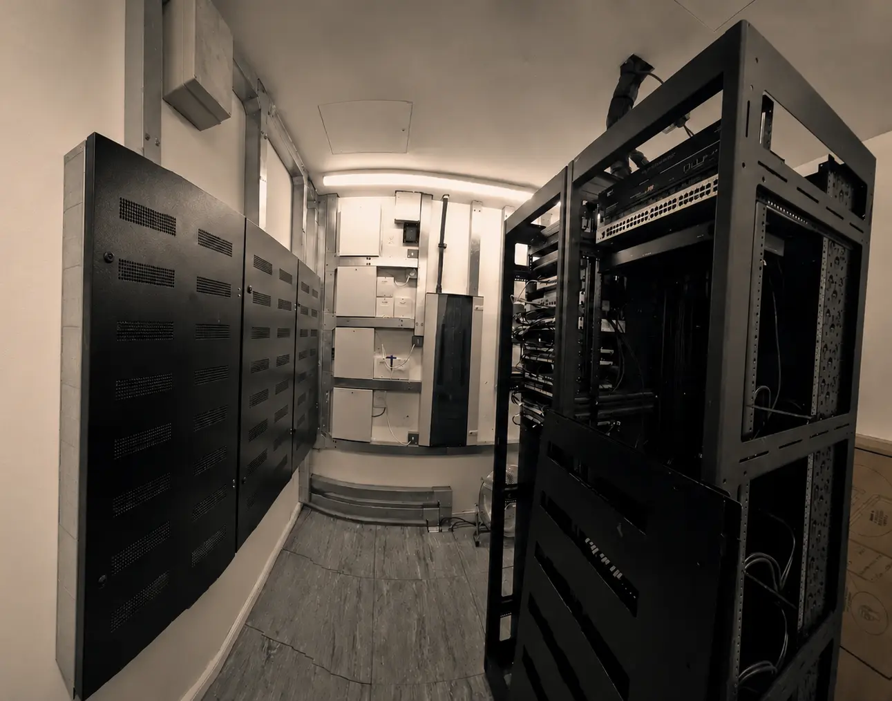 Electrical distribution cabinets and AV equipment racks in the plant room of a Notting Hill residence.