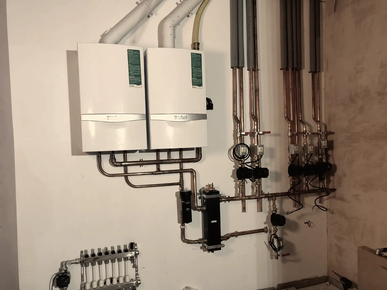 Twin-boiler heating installation with zoned copper distribution in a Notting Hill plant room.